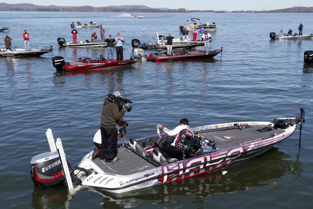 Randall Tharp, Port Saint Joe, Fla., holds up a bass for spectators following him on the second day of the Bassmaster Classic, Saturday, Feb. 22, 2014, in Guntersville, Ala. Tharp was bumped from first to second by 1 ounce by Edwin Evers, Talala, Okla. The field will be cut to the top 25 anglers for the final day of competition. (AP Photo/Hal Yeager)