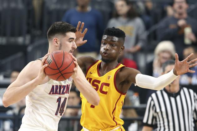 Arizona's Dusan Ristic, left, looks to pass the ball as Southern California's Chimezie Metu defends during the first half of an NCAA college basketball game in the Pac-12 men's tournament final Saturday, March 10, 2018, in Las Vegas. (AP Photo/Isaac Brekken)