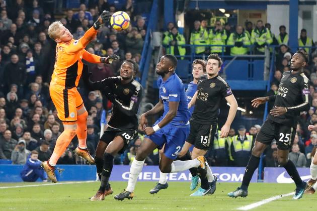 Leicester City's Danish goalkeeper Kasper Schmeichel (L) comes out to punch the ball clear during the English Premier League football match between Chelsea and Leicester City at Stamford Bridge in London on January 13, 2018. / AFP PHOTO / Tolga AKMEN / RESTRICTED TO EDITORIAL USE. No use with unauthorized audio, video, data, fixture lists, club/league logos or 'live' services. Online in-match use limited to 75 images, no video emulation. No use in betting, games or single club/league/player publications.  /         (Photo credit should read TOLGA AKMEN/AFP/Getty Images)