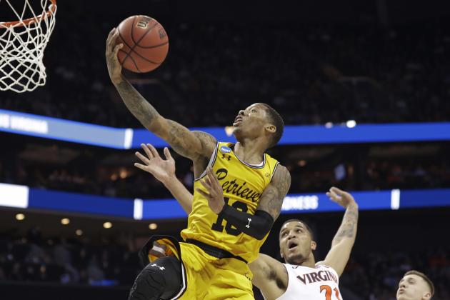 UMBC's Jairus Lyles (10) drives past Virginia's Isaiah Wilkins (21) and Kyle Guy (5) during the second half of a first-round game in the NCAA men's college basketball tournament in Charlotte, N.C., Friday, March 16, 2018. (AP Photo/Gerry Broome)