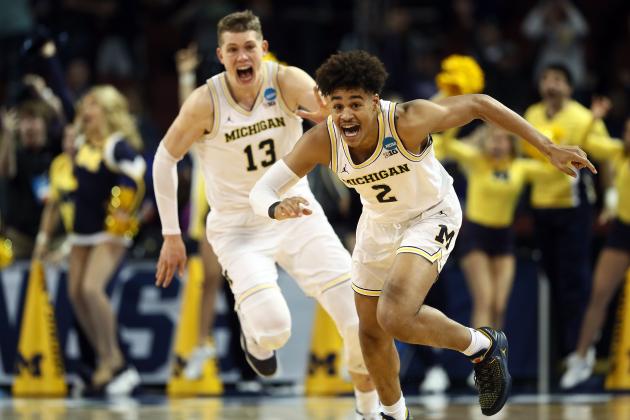 WICHITA, KS - MARCH 17:  Jordan Poole #2 and Moritz Wagner #13 of the Michigan Wolverines celebrate Poole's 3-point buzzer beater for a 64-63 win over the Houston Cougars during the second round of the 2018 NCAA Men's Basketball Tournament at INTRUST Bank Arena on March 17, 2018 in Wichita, Kansas. (Photo by Jamie Squire/Getty Images)