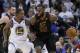 Cleveland Cavaliers forward LeBron James (23) moves the ball around Golden State Warriors forward Kevin Durant (35) during the second half of an NBA basketball game in Oakland, Calif., Monday, Dec. 25, 2017. The Warriors won 99-92. (AP Photo/Tony Avelar)