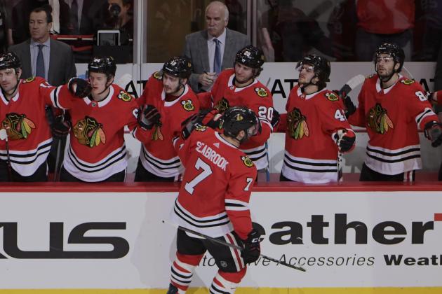 Chicago Blackhawks defenseman Brent Seabrook (7) is congratulated for his goal against the Colorado Avalanche during the first period of an NHL hockey game Tuesday, March 20, 2018, in Chicago. (AP Photo/David Banks)