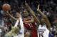 North Carolina State guard Kiara Leslie (11) shoots between Mississippi State guard Blair Schaefer (1) and center Teaira McCowan (15) during the first half of a women's NCAA college basketball tournament regional semifinal game, Friday, March 23, 2018, in Kansas City, Mo. (AP Photo/Orlin Wagner)