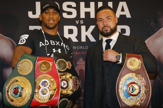 World Heavyweight boxers Anthony Joshua of Britain, left, and New Zealand's Joseph Parker hold their belts as they pose for photographers after a media conference in London, Tuesday, Jan. 16, 2018. Their unification title bout with Joshua's IBF, WBA (Super) and IBO heavyweight titles and Parker's WBO heavyweight title on the line will take place at the Principality Stadium in Cardiff on March 31, 2018.(AP Photo/Frank Augstein)