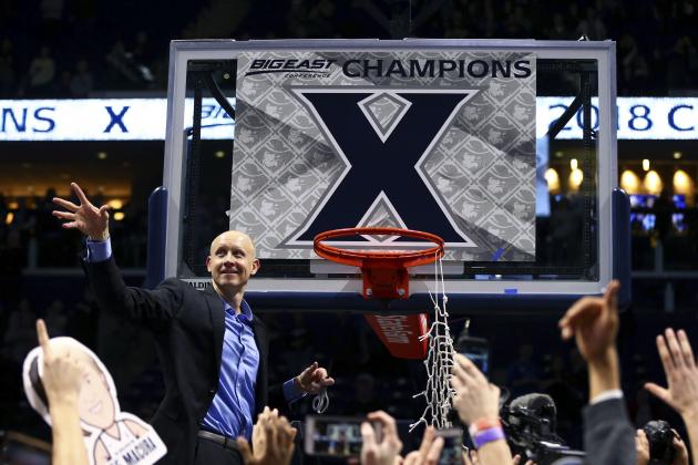 Xavier's head coach Chris Mack throws a piece of net after clinching the Big East title after an NCAA college basketball game against Providence, Wednesday, Feb. 28, 2018, in Cincinnati. Xavier won 84-74. (AP Photo/Aaron Doster)