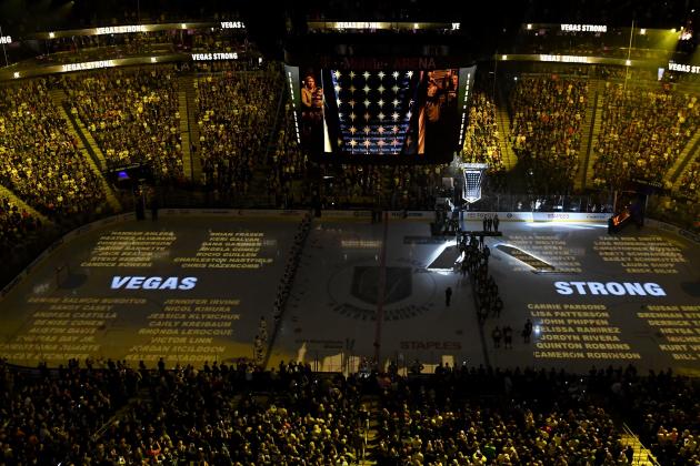 LAS VEGAS, NV - MARCH 31:  Names of the 58 victims of the October 1, 2017 mass shooting in Las Vegas are projected on the ice as the Vegas Golden Knights hang a banner in the rafters with 58 stars and the names of all the victims of the shooting as they retire the number 58 in honor of the 58 victims before a game against the San Jose Sharks at T-Mobile Arena on March 31, 2018 in Las Vegas, Nevada. The Golden Knights won 3-2 and clinched the Pacific Division title.  (Photo by Ethan Miller/Getty Images)
