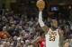 Cleveland Cavaliers' LeBron James celebrates during the first half of an NBA basketball game against the New Orleans Pelicans in Cleveland, Friday, March 30, 2018. James broke Michael Jordan's NBA record by scoring at least 10 points in his 867th straight regular-season game. (AP Photo/Phil Long)