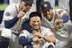 Houston Astros' Alex Bregman, left, Jose Altuve, center, and Carlos Correa show their World Series rings before the team's baseball game against the Baltimore Orioles, Tuesday, April 3, 2018, in Houston. (AP Photo/Eric Christian Smith)