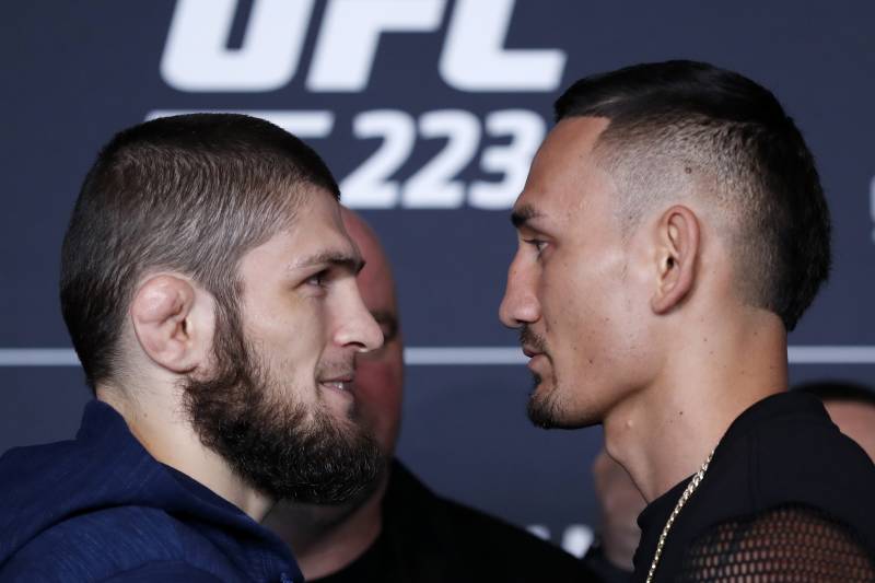 Khabib Nurmagomedov, left, faces his opponent, Max Holloway, Thursday, April 5, 2018, at the Barclays Center in New York. The pair face each other Saturday in the UFC 223 Mixed Martial Arts main event for the lightweight championship. (AP Photo/Kathy Willens)