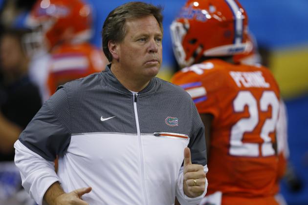 Florida head coach Jim McElwain runs out on the field before the first half of the Southeastern Conference championship NCAA college football game between Alabama and Florida, Saturday, Dec. 3, 2016, in Atlanta.(AP Photo/Butch Dill)