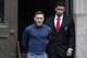 Ultimate fighting star Conor McGregor, left, is led by an official to an unmarked vehicle while leaving the 78th Precinct of the New York Police Department, Friday, April 6, 2018, in the Brooklyn borough of New York. McGregor is facing criminal charges in the wake of a backstage melee he allegedly instigated that has forced the removal of three fights from UFC's biggest card of the year. Video footage appears to show the promotion's most bankable star throwing a hand truck at a bus full of fighters after a Thursday news conference for UFC 223 at Brooklyn's Barclays Center. (AP Photo/Julio Cortez)