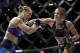 FILE - In this Dec. 30, 2016, file photo, Amanda Nunes, right, connects with Ronda Rousey in the first round of their women's bantamweight championship mixed martial arts bout at UFC 207, in Las Vegas. Rousey is in South America to film the action thriller