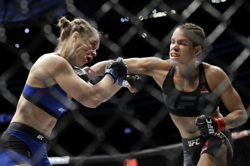 FILE - In this Dec. 30, 2016, file photo, Amanda Nunes, right, connects with Ronda Rousey in the first round of their women's bantamweight championship mixed martial arts bout at UFC 207, in Las Vegas. Rousey is in South America to film the action thriller