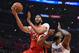 New Orleans Pelicans forward Anthony Davis, left, shoots as Los Angeles Clippers center DeAndre Jordan defends during the first half of an NBA basketball game Monday, April 9, 2018, in Los Angeles. (AP Photo/Mark J. Terrill)