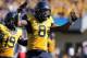 FILE - In this Oct. 14, 2017, file photo, West Virginia safety Kyzir White (8) gestures during the an NCAA college football game against Texas Tech in Morgantown, W.Va. Kyzir White had his team-leading third interception of the season to seal a 46-35 win over Texas Tech on Saturday. He also tied for the team high with nine tackles and forced a fumble. (AP Photo/Raymond Thompson, File)