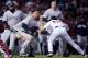 New York Yankees' Tyler Austin, center, rushes Boston Red Sox relief pitcher Joe Kelly, right, after being hit by a pitch during the seventh inning of a baseball game at Fenway Park in Boston, Wednesday, April 11, 2018. At left holding back Austin is Red Sox catcher Christian Vazquez. (AP Photo/Charles Krupa)