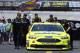 The crew of Paul Menard pushes his car through the pits after practice for a NASCAR Cup series auto race, Friday, April 13, 2018, in Bristol, Tenn. (AP Photo/Wade Payne)