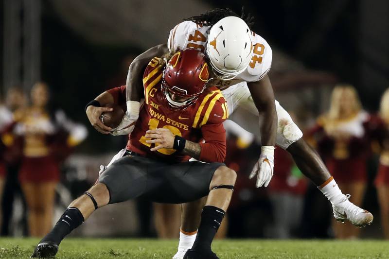 FILE - In this Sept. 28, 2017, file photo, Iowa State quarterback Jacob Park is sacked by Texas linebacker Malik Jefferson (46) during the second half of an NCAA college football game in Ames, Iowa. Don’t expect a typical high-scoring Big 12 game when Texas plays Kansas State this week. While the Longhorns have struggled offensively, their defense is coming off an impressive performance in a 17-7 win at Iowa State, (AP Photo/Charlie Neibergall, File)