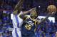 Utah Jazz guard Donovan Mitchell (45) shoots as Oklahoma City Thunder forward Jerami Grant, left, defends in the second half of Game 1 of an NBA basketball first-round playoff series in Oklahoma City, Sunday, April 15, 2018. (AP Photo/Sue Ogrocki)