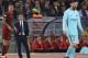 Barcelona coach Ernesto Valverde, second left, watches his players as Roma's Juan Jesus, left, and Barcelona's Lionel Messi, right, wait for the game to resume during the Champions League quarterfinal second leg soccer match between between Roma and FC Barcelona, at Rome's Olympic Stadium, Tuesday, April 10, 2018. (AP Photo/Gregorio Borgia)