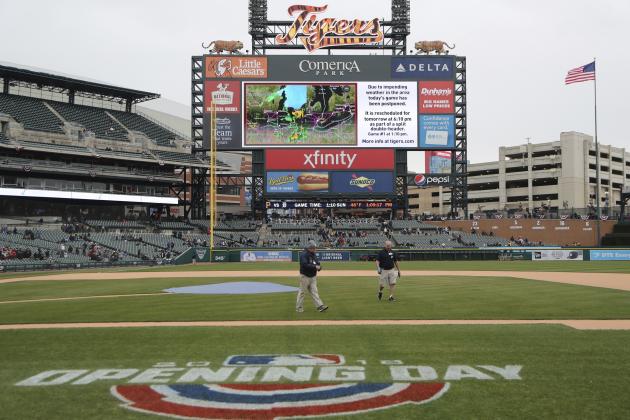 Comerica Park grounds crew prepare to roll out the tarp after the baseball game between the Detroit Tigers and the Pittsburgh Pirates was postponed, Saturday, March 31, 2018, in Detroit. The teams will play a doubleheader on Sunday. (AP Photo/Carlos Osorio)