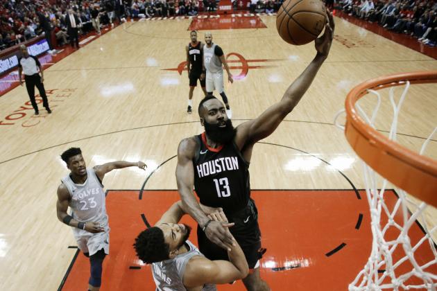 Houston Rockets guard James Harden (13) drives to the basket over Minnesota Timberwolves center Karl-Anthony Towns during the first half in Game 2 of a first-round NBA basketball playoff series Wednesday, April 18, 2018, in Houston. (AP Photo/Eric Christian Smith)