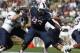 Connecticut defensive lineman Foley Fatukasi (93) during the second quarter of an NCAA college football game against Navy, Saturday, Sept. 26, 2015, in East Hartford, Conn. Three years after Superstorm Sandy forced his family from their home, Connecticut's Fatukasi has settled into a central part of the Huskies defensive line. (AP Photo/Stew Milne)