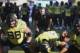 FILE - In this Oct. 28, 2017, file photo, Oregon co-offensive coordinator Mario Cristobal watches a special team warmup drill before an NCAA college football game against Utah, in Eugene, Ore. A person with direct knowledge of the situation says Oregon will hire Mario Cristobal as its head coach. The person spoke to The Associated Press on condition of anonymity because a deal and announcement were still being finalized. Cristobal was offensive coordinator at Oregon this past season and was named interim coach on Tuesday, Dec. 5, 2017, when Willie Taggart left to become coach at Florida State. (AP Photo/Chris Pietsch, File)
