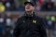 Michigan head coach Jim Harbaugh looks up at the scoreboard in the second quarter of an NCAA college football game against Ohio State in Ann Arbor, Mich., Saturday, Nov. 25, 2017. (AP Photo/Tony Ding)