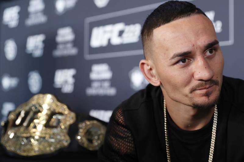 UFC featherweight champion Max Holloway responds to reporters' questions during a media event, Thursday, April 5, 2018, in New York, ahead of his lightweight title fight against Max Nurmamogedov, Saturday, April 7th. (AP Photo/Kathy Willens)