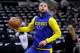FILE - In this April 19, 2018 file photo, Golden State Warriors guard Stephen Curry (30) warms up before Game 3 of the team's first-round NBA basketball playoff series against the San Antonio Spurs in San Antonio. Curry has been cleared to take part in modified practices but will be out at least one more week with a left knee injury. The Warriors said Curry was examined by the team's medical staff Friday and is making progress in recovering from the grade 2 left MCL sprain that has sidelined him since March 23.(AP Photo/Eric Gay)