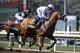 Justify, ridden by Mike Smith, gallops past Bolt d'Oro, left, with jockey Javier Castellano, during the Santa Anita Derby horse race at Santa Anita on Saturday, April 7, 2018, in Arcadia, Calif. Justify won the race, and Bolt d'Oro came in second. (AP Photo/Jae C. Hong)