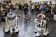 R2D2 roboters of the Star Wars movies pass visitors at the fairground in Essen, Germany, Friday, July 26, 2013. The Star Wars Celebration festival shows all around the Star Wars movies until Sunday July 28th. (AP Photo/Frank Augstein)