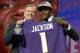 Commissioner Roger Goodell, left, presents Louisville's Lamar Jackson with his Baltimore Ravens jersey during the first round of the NFL football draft, Thursday, April 26, 2018, in Arlington, Texas. (AP Photo/David J. Phillip)