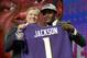 Commissioner Roger Goodell, left, presents Louisville's Lamar Jackson with his Baltimore Ravens jersey during the first round of the NFL football draft, Thursday, April 26, 2018, in Arlington, Texas. (AP Photo/David J. Phillip)