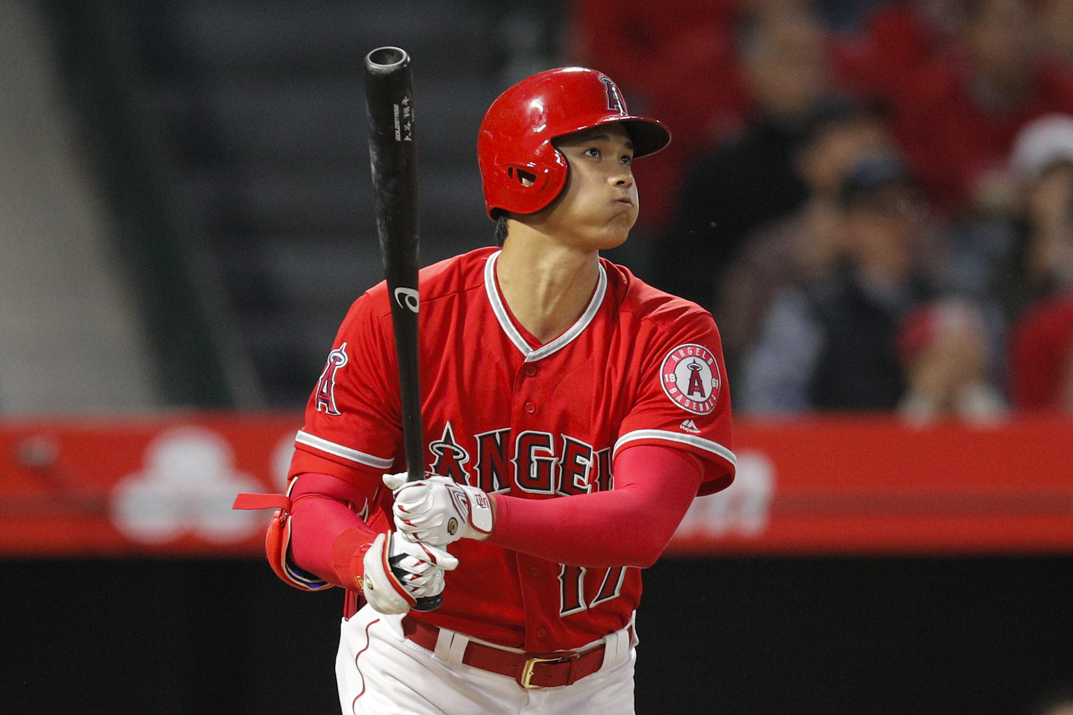 Shohei Ohtani of the Los Angeles Angels puts on pink cleats to