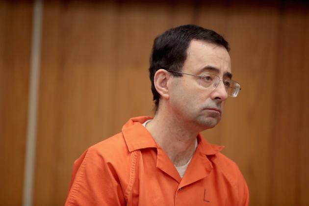 CHARLOTTE, MI - FEBRUARY 05:  Larry Nassar stands as he is sentenced by Judge Janice Cunningham for three counts of criminal sexual assault in Eaton County Circuit Court on February 5, 2018 in Charlotte, Michigan. Nassar has been accused of sexually assaulting more than 150 girls and young women while he was a physician for USA Gymnastics and Michigan State University. Cunningham sentenced Nassar to 40 to 125 years in prison. He is currently serving a 60-year sentence in federal prison for possession of child pornography. Last month a judge in Ingham County, Michigan sentenced Nassar to an 40 to 175 years in prison after he plead guilty to sexually assaulting seven girls.  (Photo by Scott Olson/Getty Images)