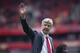 Arsenal's manager Arsene Wenger, waves to fans, as he walks around the pitch, at the end of their English Premier League soccer match against Norwich City, at Emirates stadium in London, Saturday, May 5, 2012. (AP Photo/Bogdan Maran)