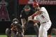 Los Angeles Angels' Albert Pujols, right, hits an RBI double as Chance Sisco, left, watches along with home plate umpire Brian Gorman during the second inning of a baseball game Thursday, May 3, 2018, in Anaheim, Calif. The double marked his 2,999th career hit. (AP Photo/Mark J. Terrill)