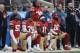San Francisco 49ers outside linebacker Eli Harold, from bottom left, kneels with safety Eric Reid, wide receiver Marquise Goodwin and wide receiver Louis Murphy during the national anthem before an NFL football game against the Jacksonville Jaguars in Santa Clara, Calif., Sunday, Dec. 24, 2017. (AP Photo/Marcio Jose Sanchez)
