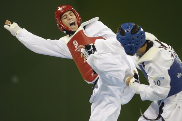FILE - In this Aug. 22, 2008, Steven Lopez, of the U.S., left, fights Turkey's Bahri Tanrikulu during a preliminary match for the men's taekwondo -80 kilogram class at the Beijing 2008 Olympics in Beijing. This will be the fourth and maybe Olympic Games for the 33-year-old athlete, who has taken home gold twice. (AP Photo/David Guttenfelder, File)