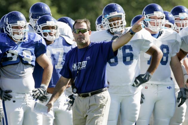Buffalo coach Jim Hofher, center, instructs the team during practice in Amherst, N.Y., Thursday, Aug. 25, 2005. Armed with a contract extension and an increased commitment to his football program by a new athletics director, Buffalo coach Jim Hofher is hopeful these off-field developments translate into an improved product on the field. (AP Photo/David Duprey)
