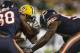FILE - In this Thursday, Sept. 28, 2017, file photo, Green Bay Packers' Davante Adams is hit by Chicago Bears' Adrian Amos and Danny Trevathan during the second half of an NFL football game, in Green Bay, Wis. Adams was lucky he wasn't more seriously injured on Trevathan's illegal hit on the Green Bay receiver. And Chicago's thumping linebacker, who was flagged and suspended for two games, is fortunate he wasn't ejected. (AP Photo/Matt Ludtke, File)