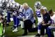 FILE - In this Monday, Sept. 25, 2017, file photo, the Dallas Cowboys, led by owner Jerry Jones, center, take a knee prior to the national anthem and an NFL football game against the Arizona Cardinals, in Glendale, Ariz. ESPN anchor Jemele Hill has been suspended by the network for two weeks for making political statements on social media. Hill, who is African-American, received criticism from the network last month after referring to President Donald Trump as a