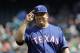 Texas Rangers starting pitcher Bartolo Colon salutes a teammate as he walks to the dugout during a baseball game against the Seattle Mariners, Wednesday, May 16, 2018, in Seattle. (AP Photo/Ted S. Warren)