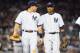 NEW YORK, NY - OCTOBER 14: (NEW YORK DAILIES OUT) Mark Teixeira #25 (L) and Robinson Cano #24 of the New York Yankees look on against the Detroit Tigers during Game Two of the American League Championship Series at Yankee Stadium on October 14, 2012 in the Bronx borough of New York City, New York.. The Tigers defeated the Yankees 3-0. (Photo by Jim McIsaac/Getty Images)