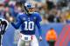 EAST RUTHERFORD, NJ - DECEMBER 31: (NEW YORK DAILIES OUT) Eli Manning #10 of the New York Giants reacts after throwing a touchdown pass in the first half against the Washington Redskins on December 31, 2017 at MetLife Stadium in East Rutherford, New Jersey. The Giants defeated the Redskins 18-10. (Photo by Jim McIsaac/Getty Images)