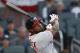 Washington Nationals left fielder Howie Kendrick (12) drives in a run with a double in the first inning of a baseball game against the Atlanta Braves Monday, April 2, 2018, in Atlanta. (AP Photo/John Bazemore)