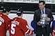 FILE - In this Feb. 23, 2015, file photo Boston University hockey head coach David Quinn, right, hands the Beanpot trophy to Matt Grzelcyk (5) and Evan Rodrigues, left, after their overtime win against Northeastern in Boston. NHL teams are thinking outside the box to find coaches. Quinn has been linked to the Rangers but will stay at least one more year and run the U.S. world junior team like Housley before likely being the next to graduate from college to the NHL. (AP Photo/Charles Krupa, file)